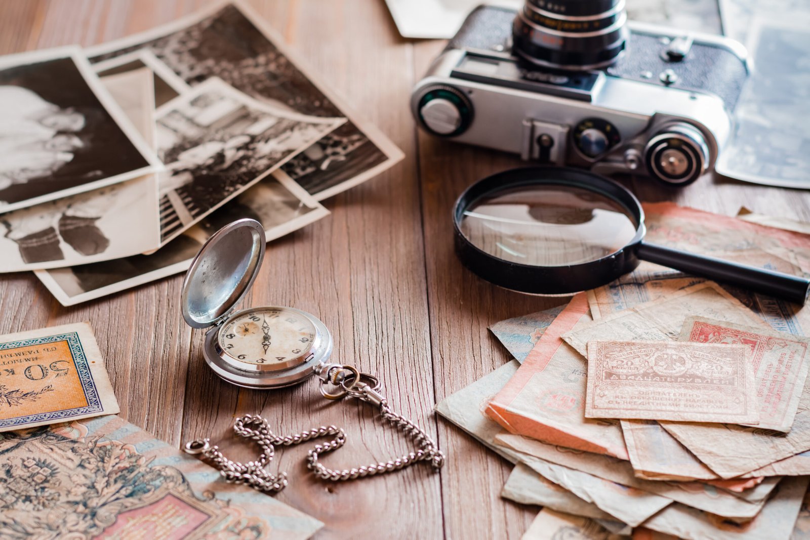 A watch on a chain, aged ruble bills, a film camera and black an